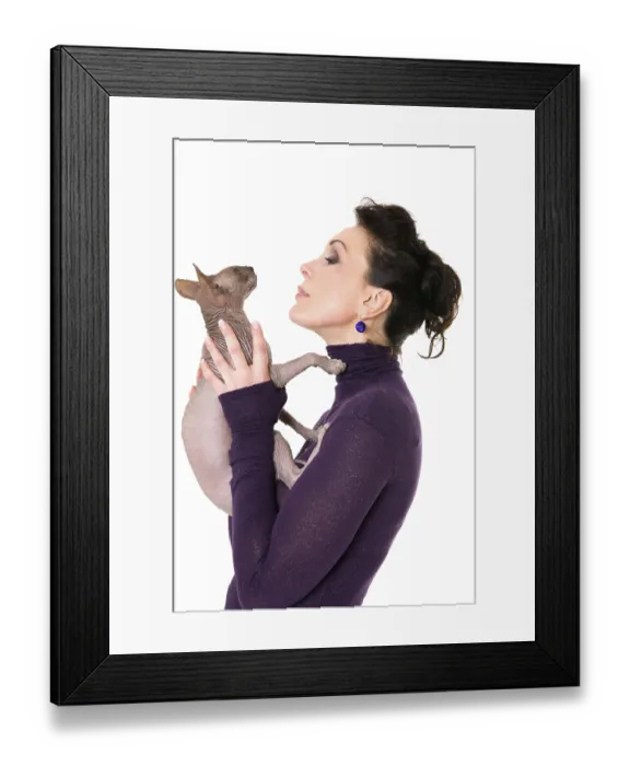 Framed Print : Pretty model posing in studio with a cat Framed Print : Pretty model posing in studio with a cat