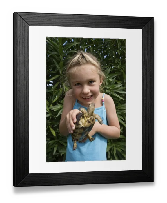 Framed Print : Child with tortoise, Sardinia, Italy