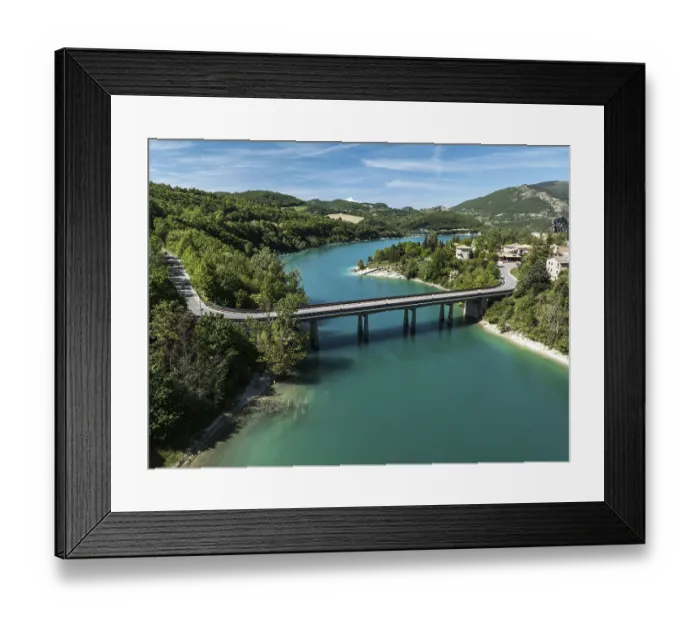 Framed Print : Aerial view of a bridge spanning the vibrant turquoise waters of Lago di Fiastra