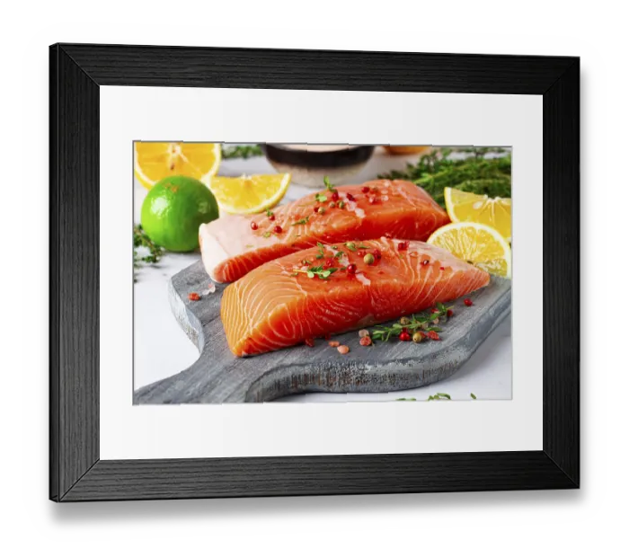 Framed Print : Two pieces of salmon fillet sit on a wooden cutting board