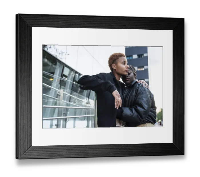 Framed Print : A loving LGBT multiethnic couple embraces outdoors in an urban environment