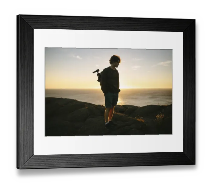 Framed Print : A young male photographer stands on the rocky terrain of Cape Spear Lighthouse Framed Print : A young male photographer stands on the rocky terrain of Cape Spear Lighthouse