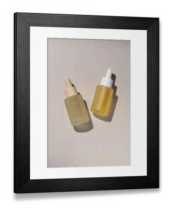Framed Print : Aesthetic presentation of two skincare serum bottles with droppers casting subtle shadows on a neutral background Ideal