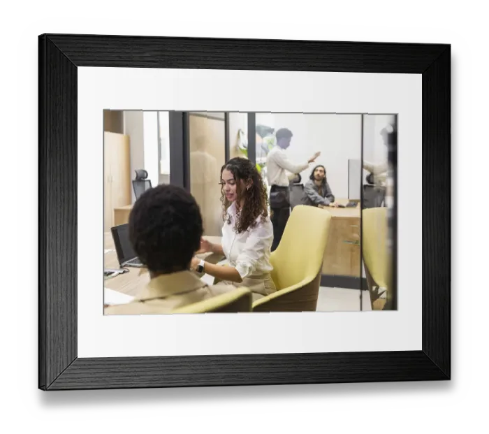 Framed Print : A diverse group of professionals engaged in work within a modern office