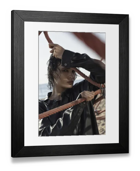 Framed Print : A woman in a black leather jacket holds onto ropes on a sunny beach Framed Print : A woman in a black leather jacket holds onto ropes on a sunny beach