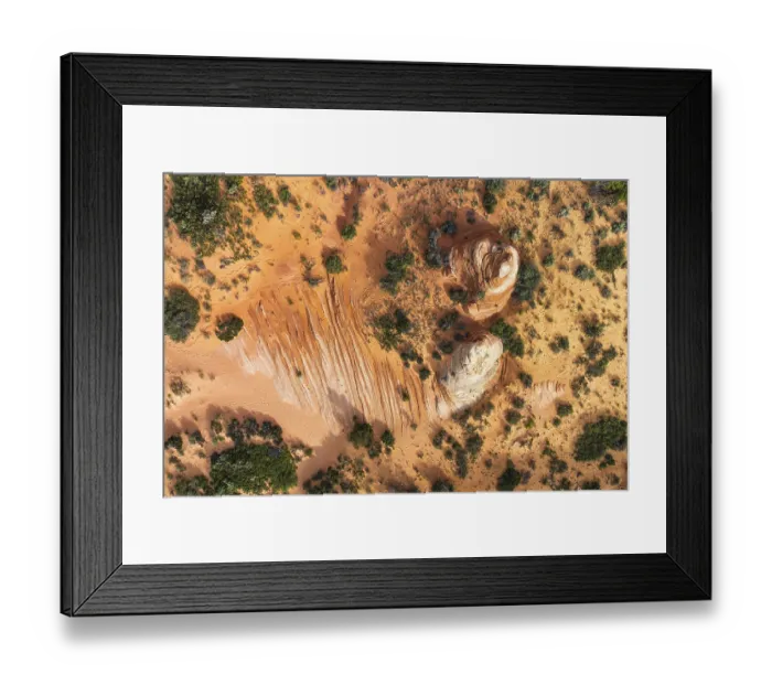 Framed Print : Aerial shot showcases a desert landscape with unique rock formations and contrasting vegetation in White Pocket
