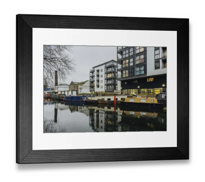 Framed Print : A serene London canal scene showcasing modern apartments alongside moored boats