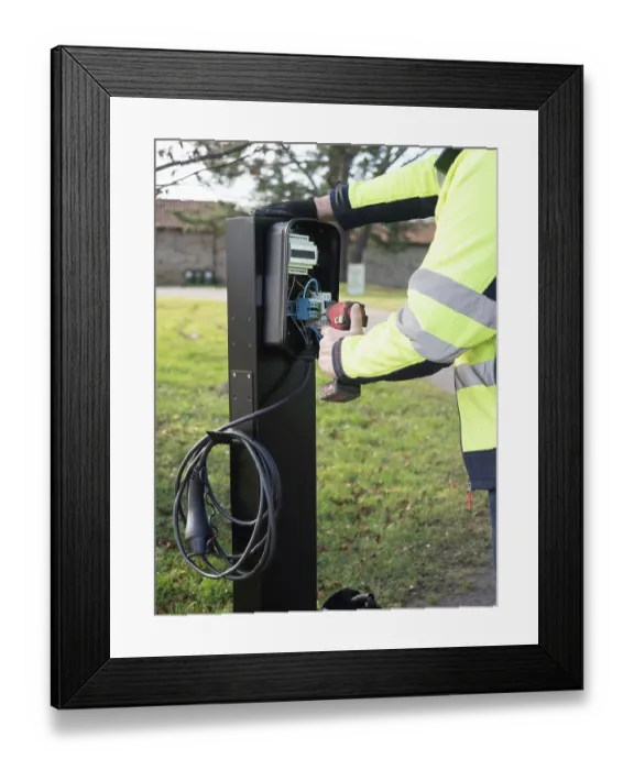 Framed Print : Worker installing an ev charging point Framed Print : Worker installing an ev charging point