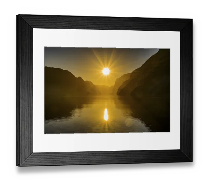 Framed Print : Atmospheric star-shaped sunlight is reflected on quiet fjord waters of Laysefjord between massive rock walls Framed Print : Atmospheric star-shaped sunlight is reflected on quiet fjord waters of Laysefjord between massive rock walls