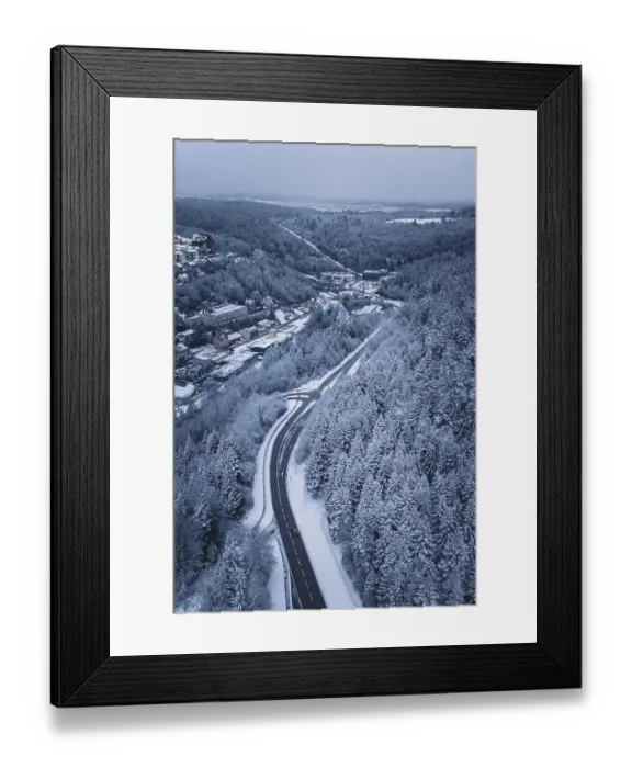 Framed Print : Snowy road through a forest, quiet winter landscape with lonely car