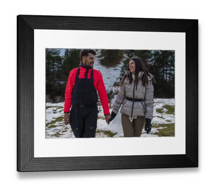 Framed Print : Smiling young couple enjoying a winter walk in the snowy mountains Framed Print : Smiling young couple enjoying a winter walk in the snowy mountains