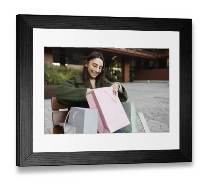 Framed Print : A young woman in a green coat sits outdoors Framed Print : A young woman in a green coat sits outdoors