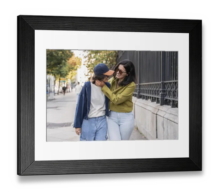 Framed Print : A joyful lesbian couple shares a loving moment while walking along a city street Framed Print : A joyful lesbian couple shares a loving moment while walking along a city street