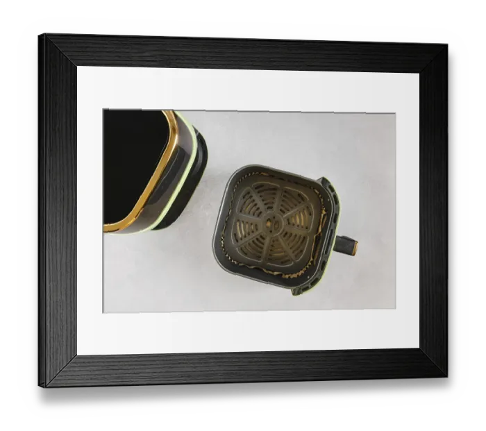 Framed Print : Top view of modern air fryer with empty basket lined with parchment paper Framed Print : Top view of modern air fryer with empty basket lined with parchment paper