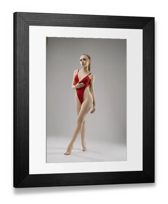 Framed Print : A graceful model stands confidently in a red swimsuit