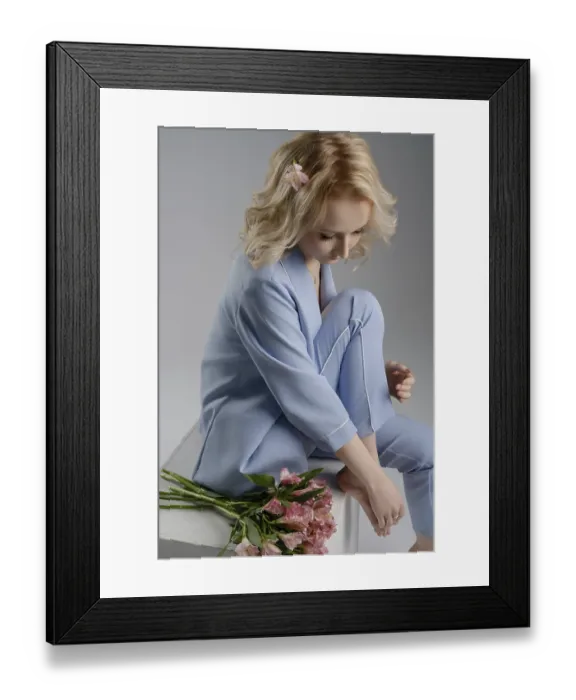 Framed Print : A woman in a light blue outfit sits gracefully Framed Print : A woman in a light blue outfit sits gracefully
