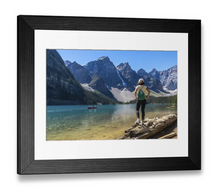 Framed Print : Female tourist standing on a log