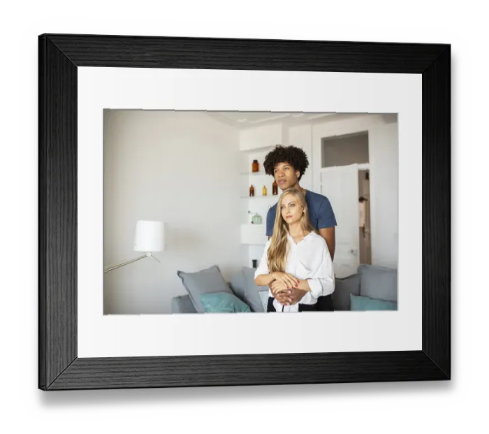Framed Print : A couple shares a tender embrace in their stylish living room