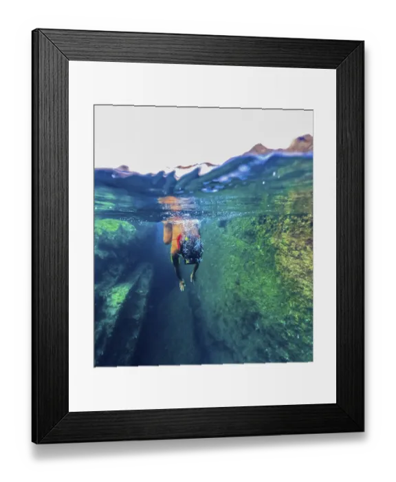 Framed Print : A female swimmer explores the clear natural pools of Tindaya Beach in Fuerteventura