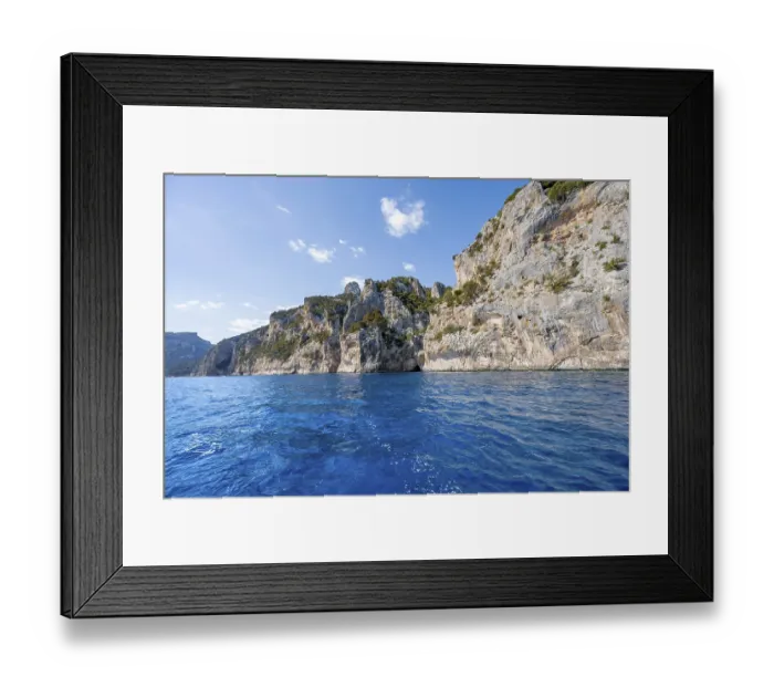 Framed Print : Picturesque rocky coast, cliffs and blue sea
