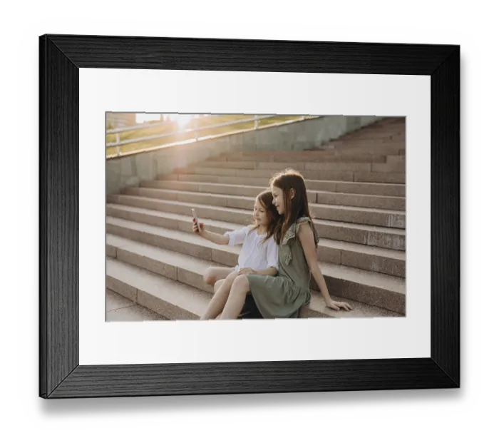 Framed Print : Two young girls sit together on sunlit stone stairs Framed Print : Two young girls sit together on sunlit stone stairs