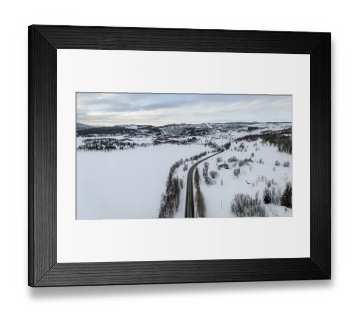 Framed Print : Aerial view of a serene Nordic winter landscape with snow-covered fields