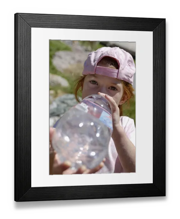 Framed Print : Girl drinking thurstily from a big water bottle