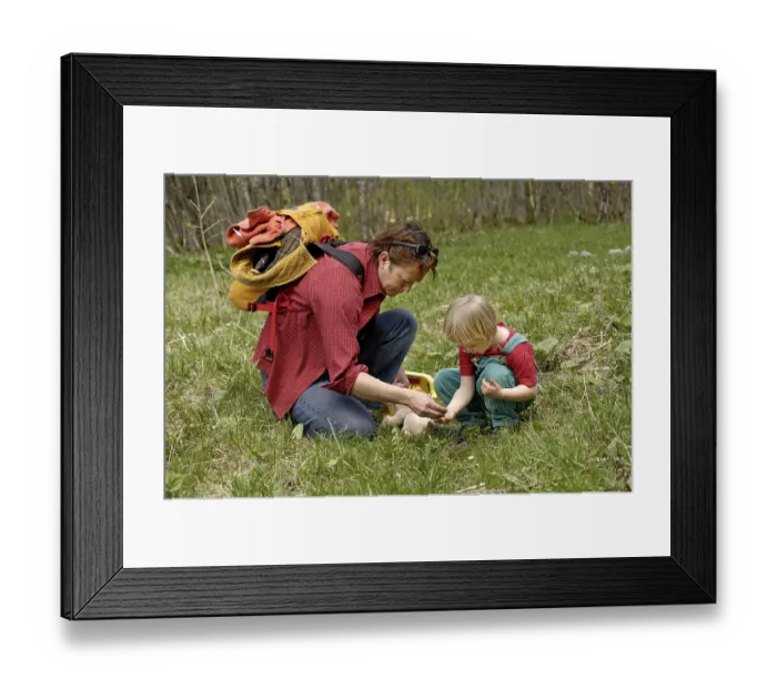 Framed Print : One mother with three-year-old girl examening an insect on a hike