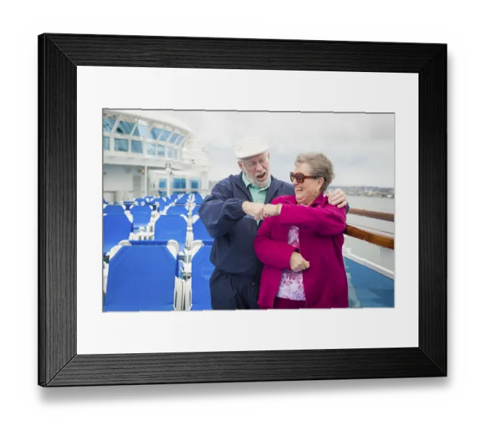 Framed Print : Happy senior couple fist bump on the deck of a luxury passenger cruise ship Framed Print : Happy senior couple fist bump on the deck of a luxury passenger cruise ship