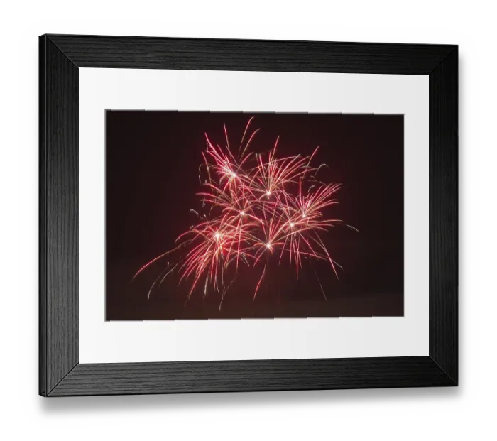 Framed Print : Red fireworks glow in vivid trails of light in the dark
