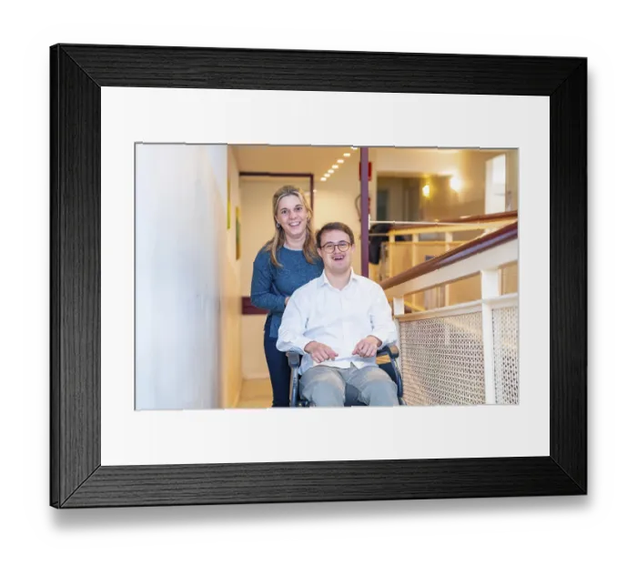 Framed Print : Happy portrait of a caregiver and man with down syndrome on wheelchair