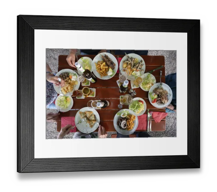 Framed Print : Greek food served on a table in a beer garden
