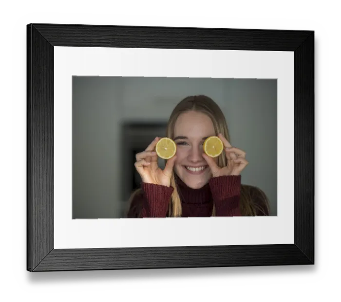 Framed Print : Young woman, cutting fruit, fooling around in the kitchen