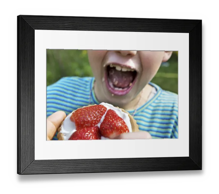Framed Print : Child eating strawberry tartlet Framed Print : Child eating strawberry tartlet
