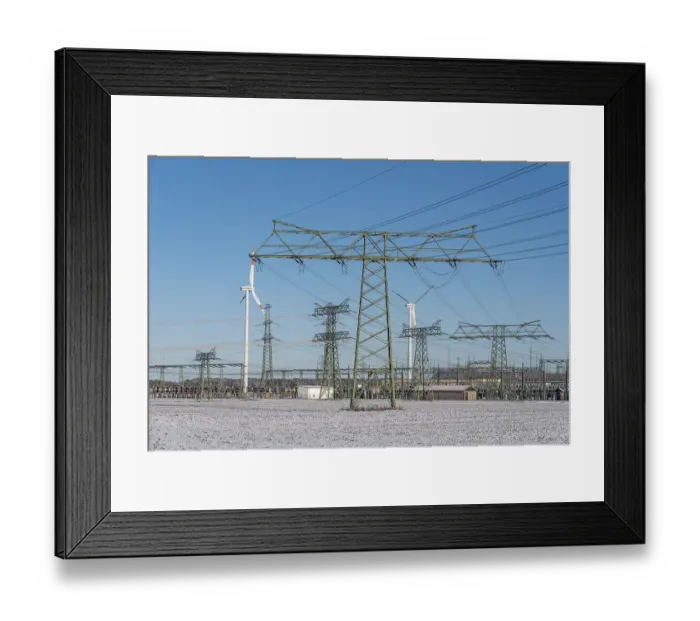 Framed Print : Power pylons, wind turbines, icy field Framed Print : Power pylons, wind turbines, icy field