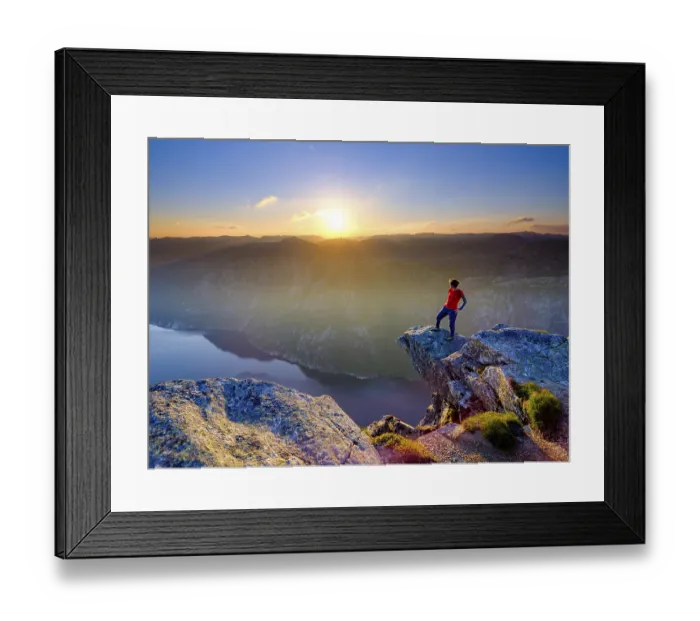 Framed Print : Woman standing on a rocky outcrop at Kjerag above the Lysefjord