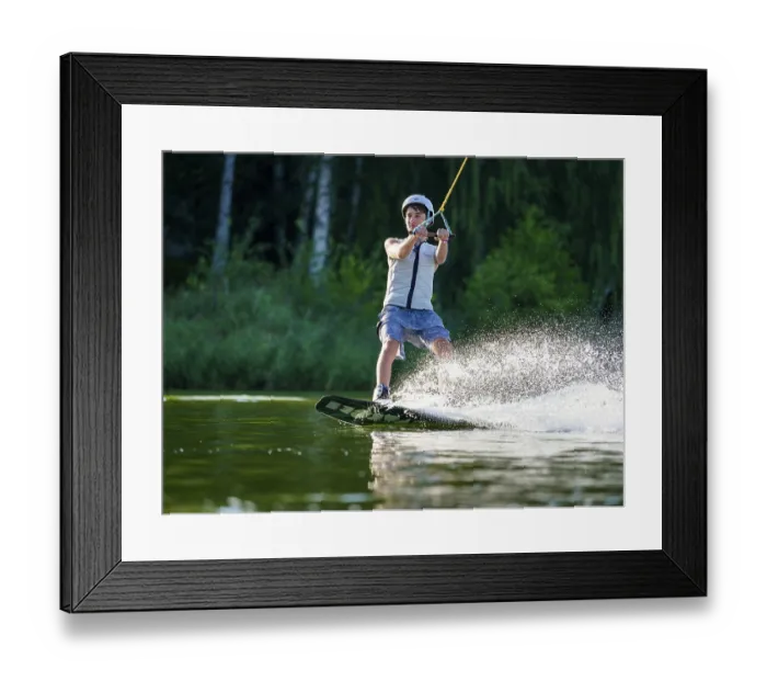 Framed Print : Sporty young man with helmet and waistcoat on wakeboard in lake