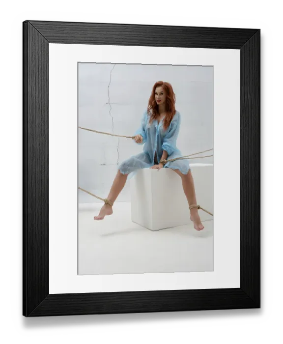 Framed Print : A woman with red hair is posed on a pedestal