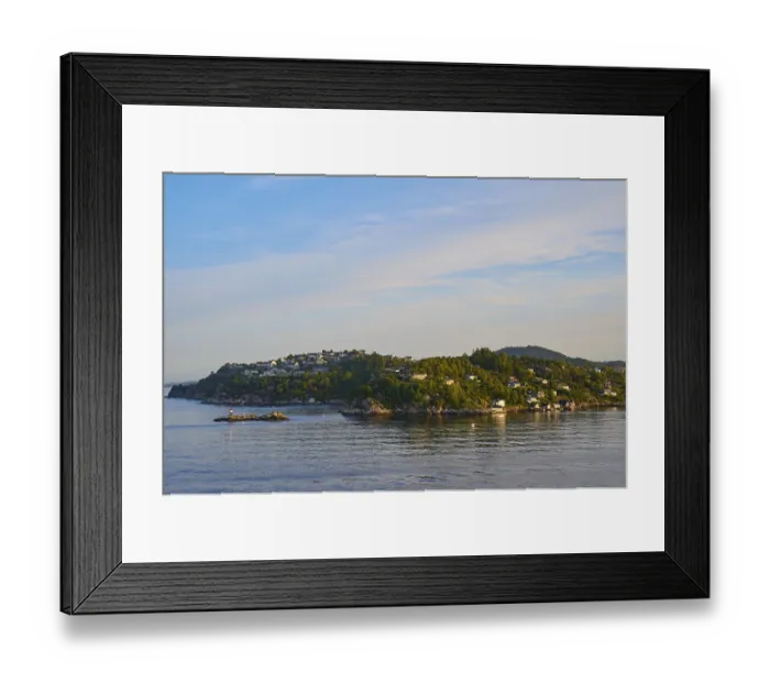 Framed Print : Small wooded island with houses in the sea with clear skies and calm water Framed Print : Small wooded island with houses in the sea with clear skies and calm water