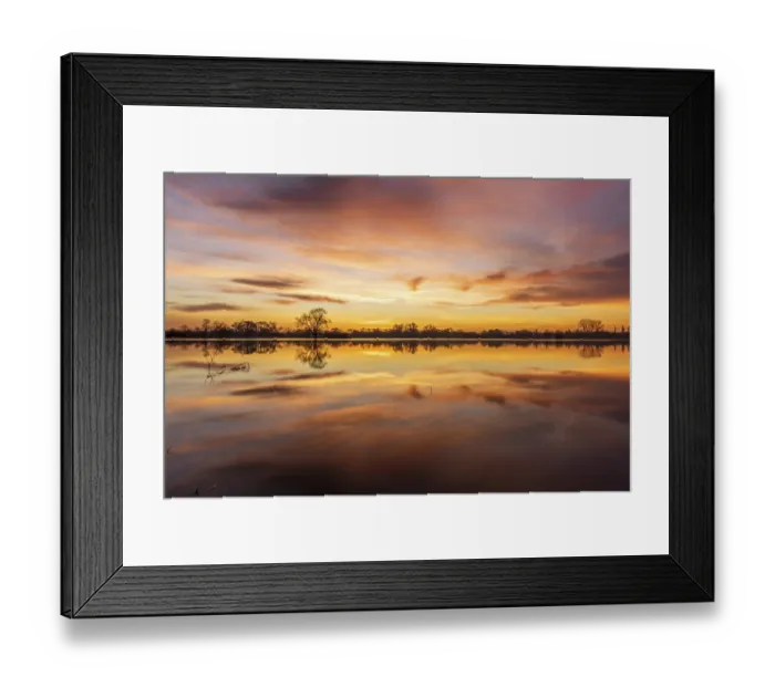 Framed Print : Reflection of the orange sky in the water of the flooded meadow at sunrise
