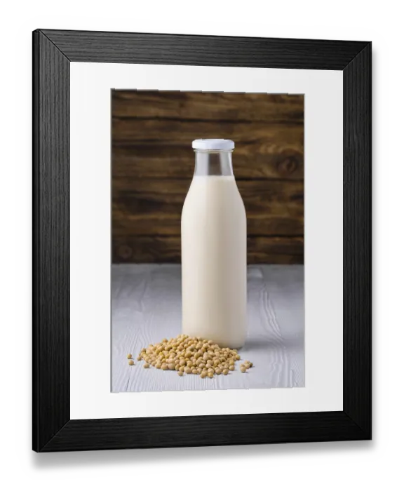 Framed Print : Bottle of soy milk with soybeans on white table over dark wooden background