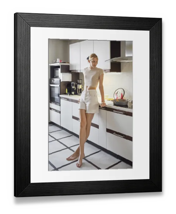 Framed Print : A woman stands casually in a bright Framed Print : A woman stands casually in a bright