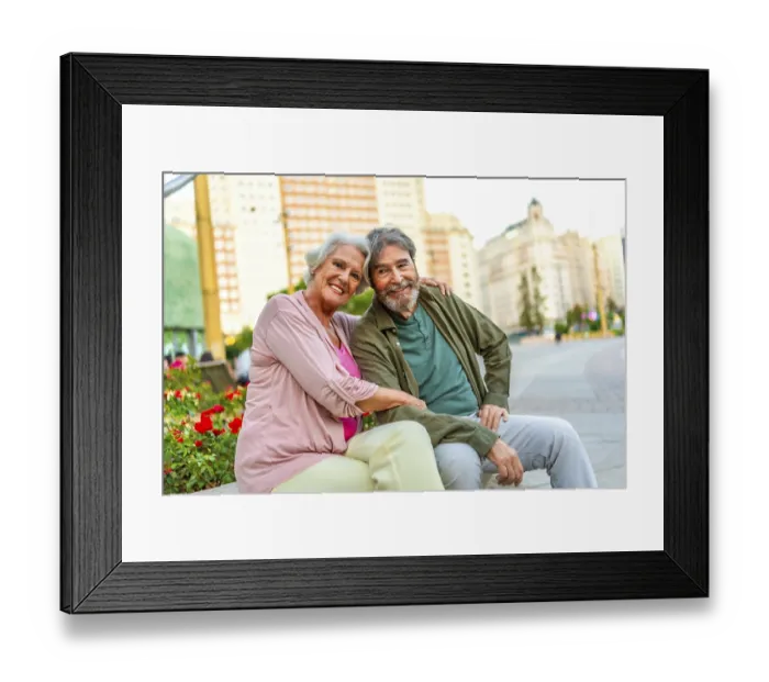 Framed Print : Senior caucasian male and female lovers sitting on city bench together