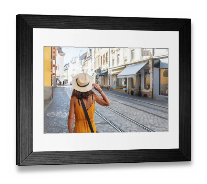 Framed Print : A woman walking through the city of Freiburg im Breisgau