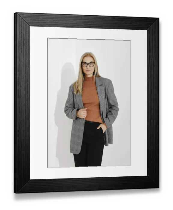 Framed Print : Portrait of a stylishly dressed woman holding one hand in her trouser pocket