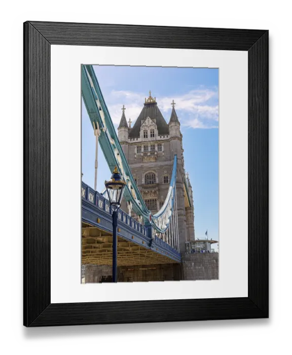 Framed Print : The historic Tower Bridge with towering structures and blue lower section under a clear sky Framed Print : The historic Tower Bridge with towering structures and blue lower section under a clear sky