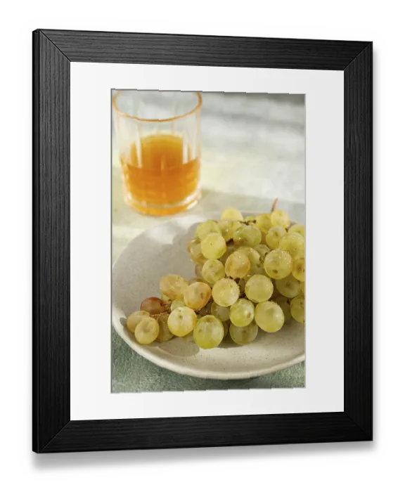 Framed Print : A branch of white grapes, on a gray plate Framed Print : A branch of white grapes, on a gray plate