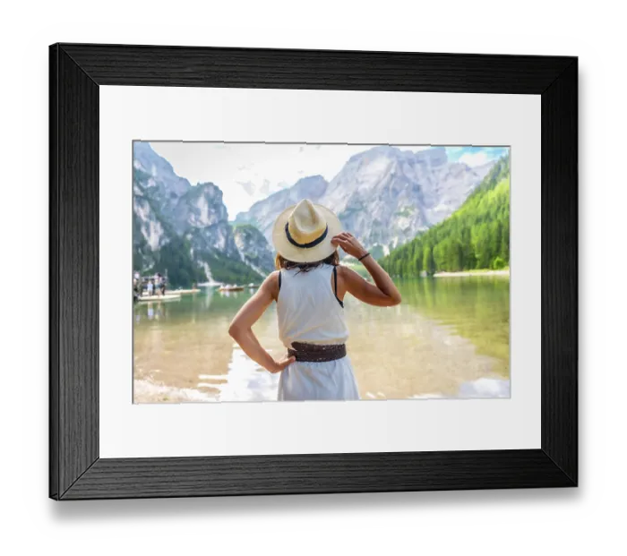 Framed Print : Woman wearing straw hat, enjoying the amazing view of lake braies in the dolomites mountains during summer