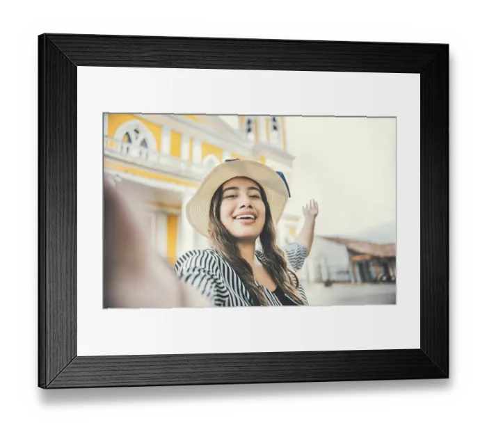 Framed Print : Lifestyle of tourist girl in hat taking a selfie in a square