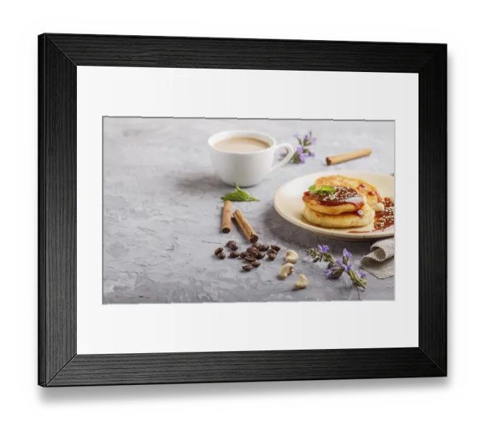 Framed Print : Cheese pancakes with caramel sauce on a beige ceramic plate and a cup of coffee on a gray concrete background